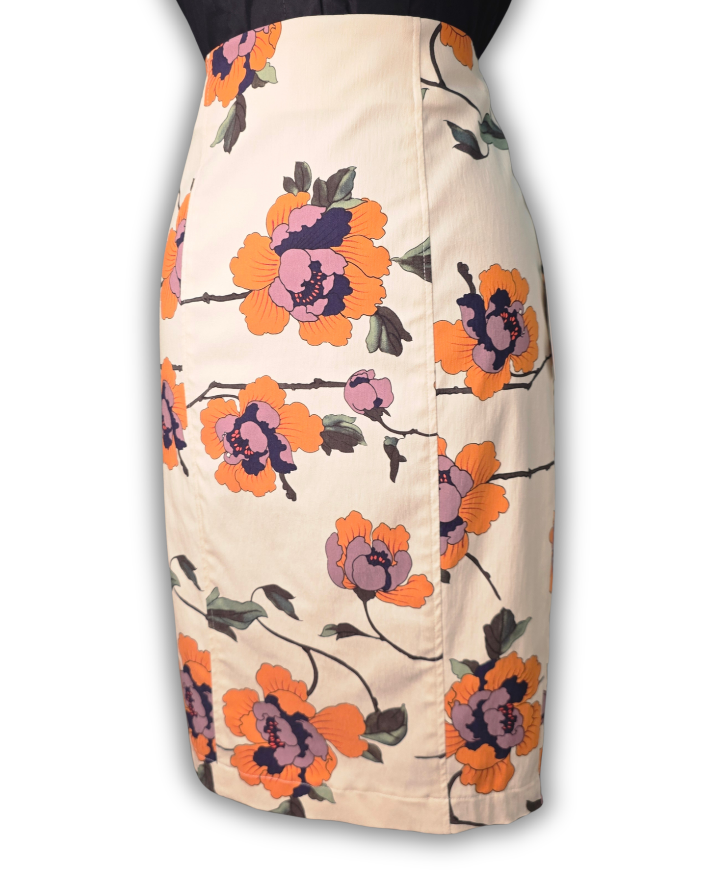 A high-waisted pencil skirt in a warm beige base color, featuring a bold floral pattern with orange, pink, and purple flowers and dark green leaves.

Ruby De Vine ladies pencil skirt handmade on the Gold Coast featuring a 1950s-inspired fitted silhouette with back split and rear zip. Now available on Rockabilly Australia.