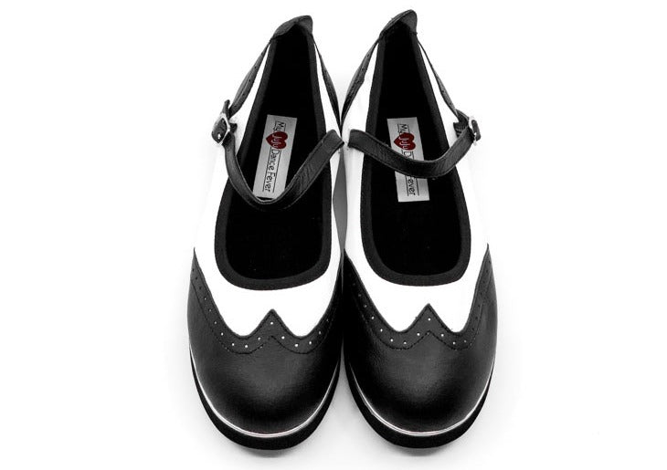 Ladies black & white classic wingtip style rock'n'roll dance flats by My Juju Dance Fever.   Hand crafted with carefully selected genuine leather for upper and inner   Single strap with elastic buckle for a stronger hold and added movement   Elegant, closed-toe wingtip design   Flat cushioned, smooth rubber sole enables you to dance on all surface types!  Super lightweight for fast movements on the dance floor.  Gel innersole for long lasting cushioned support   Stylish & comfortable design with fantastic v